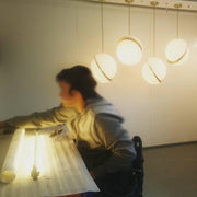 Crescent moon-shaped LED chandelier – Contemporary chic in acrylic and brass finish