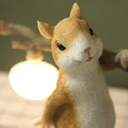Charming LED squirrel table lamp – Stylish resin and glass accent for your space