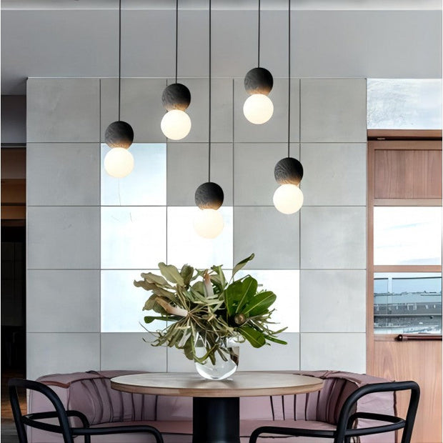 Dazzling geometric pendant light Origo – Made from volcanic stone and opal glass