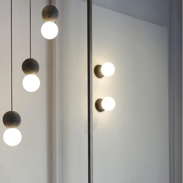 Dazzling geometric pendant light Origo – Made from volcanic stone and opal glass