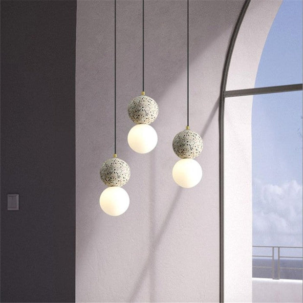 Dazzling geometric pendant light Origo – Made from volcanic stone and opal glass